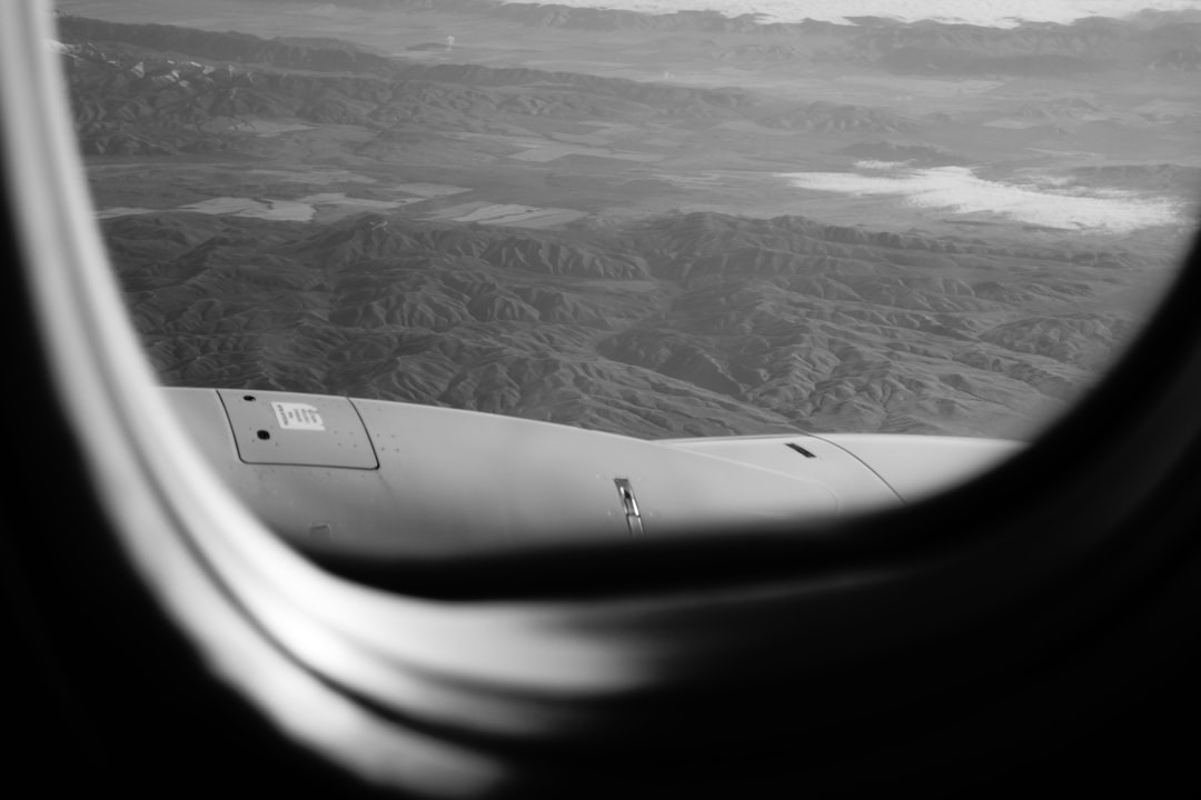 grayscale photo of mountains and clouds