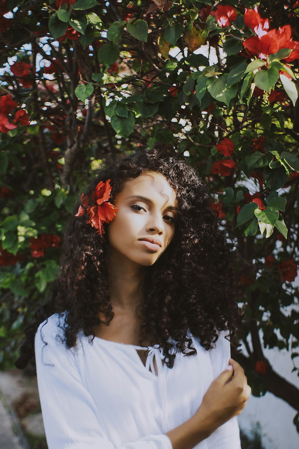 shallow focus photography of woman standing beside tree