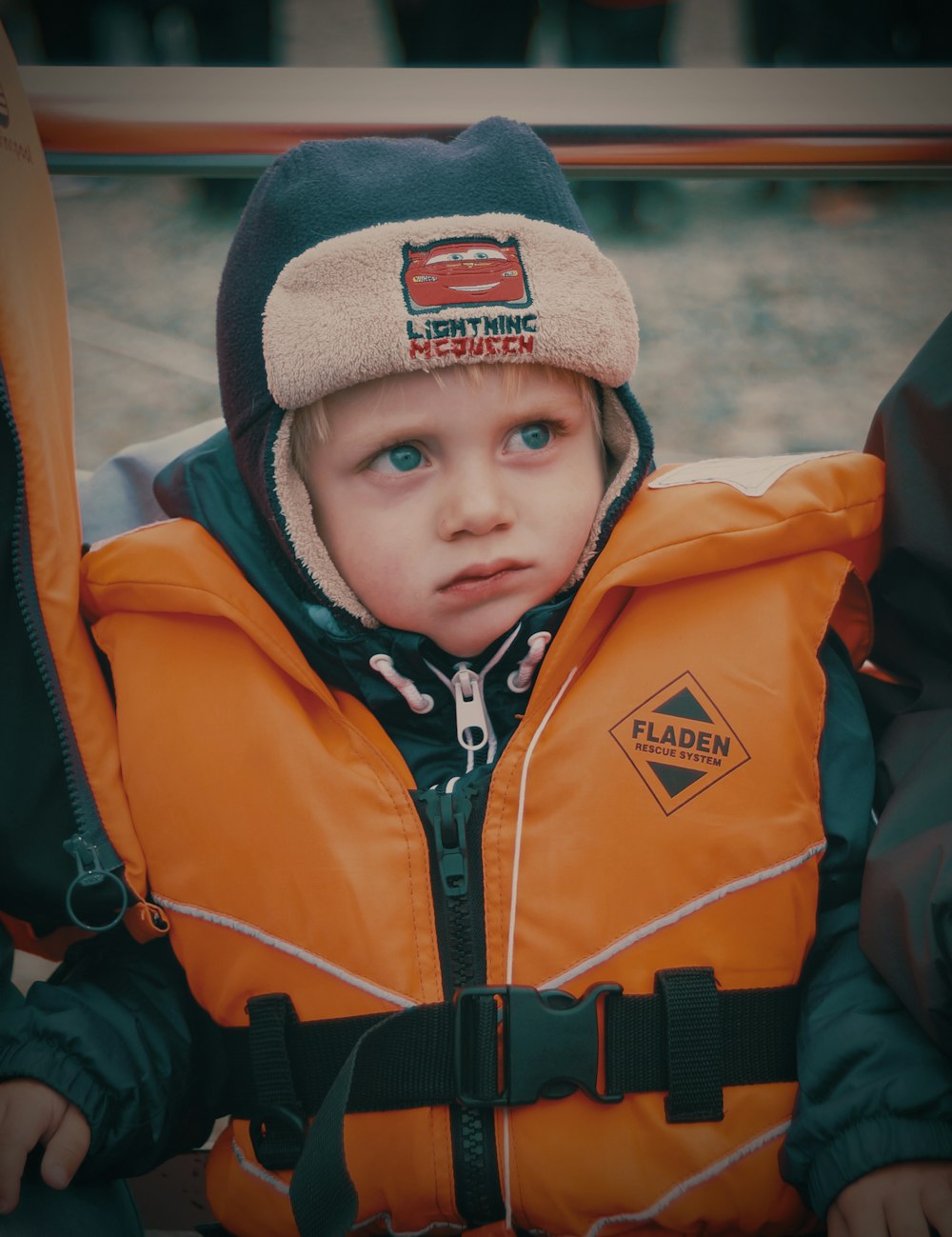 child wearing orange life vest