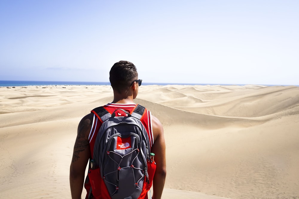 man looking at desert