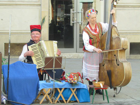 Tassos and Evelise playing bouzouki and accordion passionately on a small stage in Marseille.