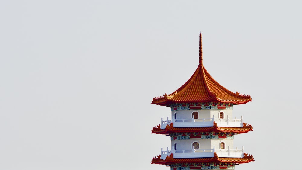 white and red pagoda under white sky