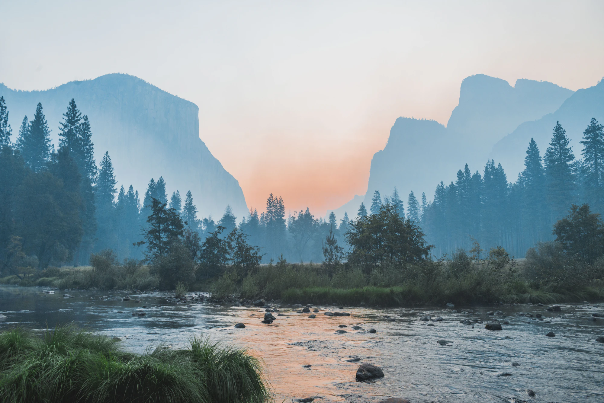 Misty river valley surrounded by evergreen forest in Southern Oregon