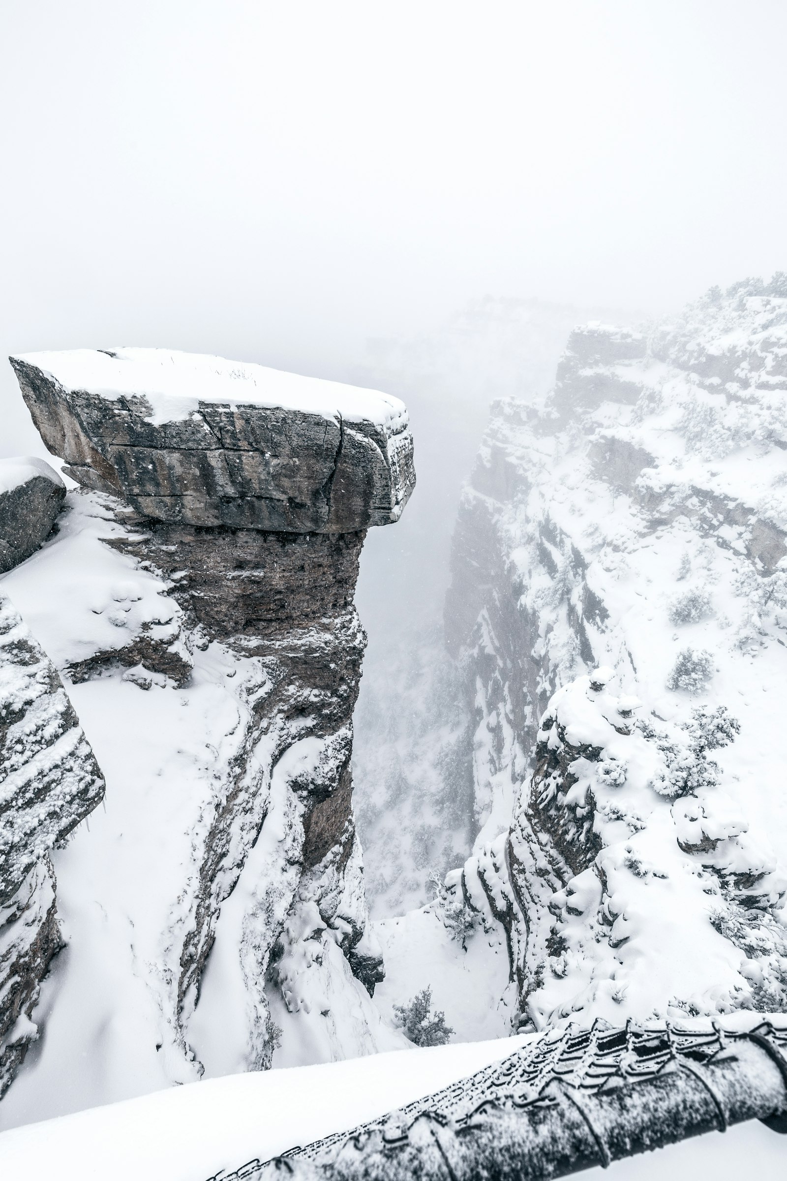 Canon EOS 6D + Canon EF 16-35mm F4L IS USM sample photo. Snowy cliff under foggy photography