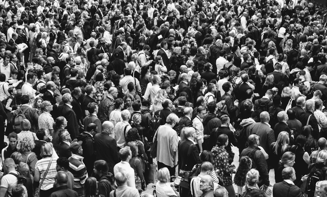 grascale photo of people standing on ground\,