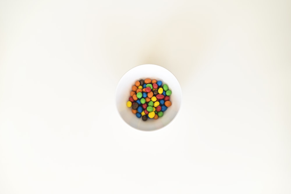 multicolored pebbles in white bowl