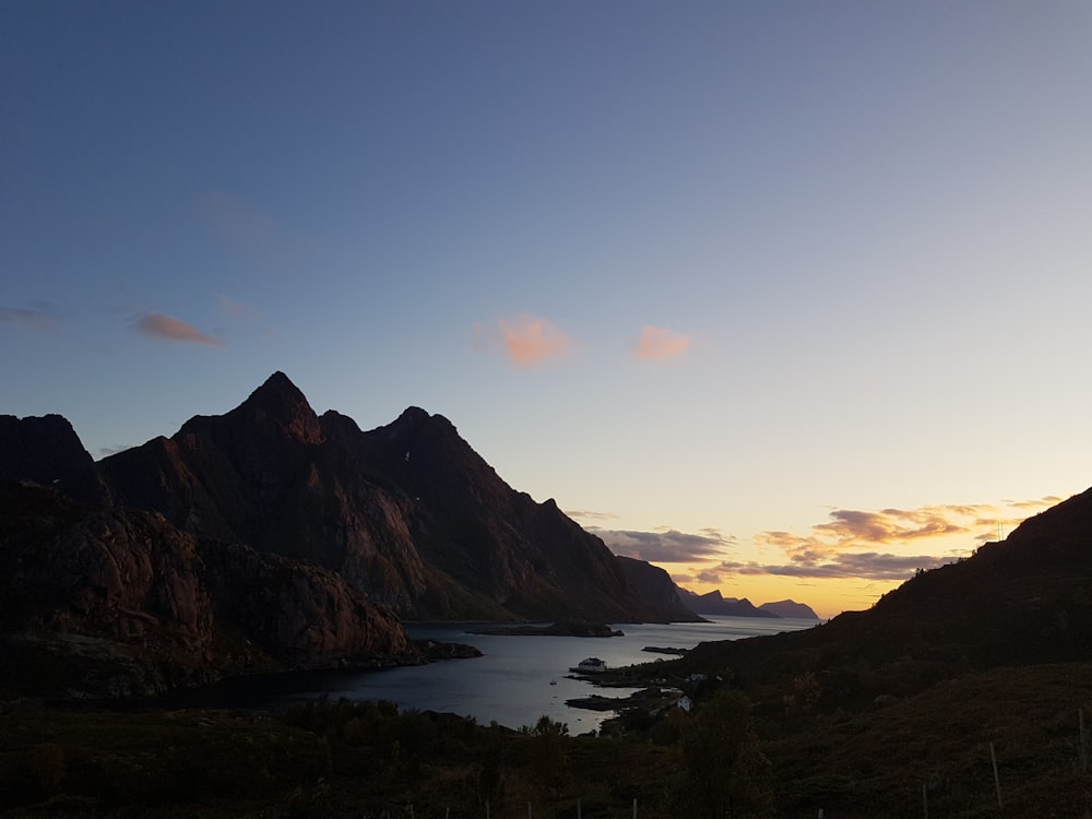 aerial view of body of water between mountains during golden hour