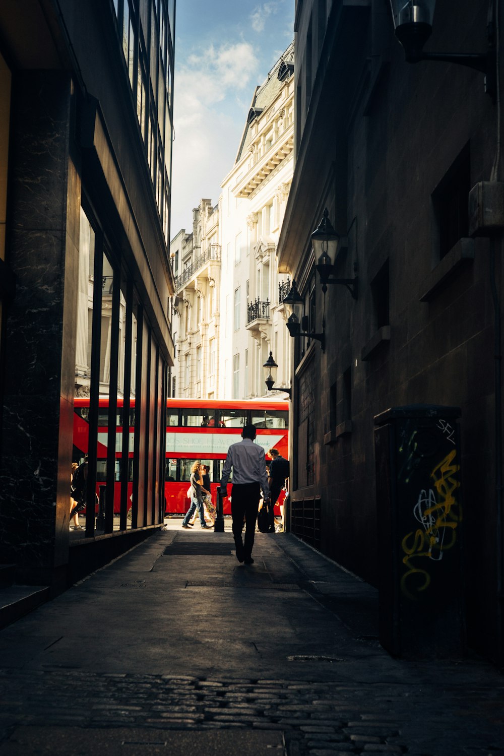 person walking on alley during daytime