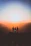 silhouette of three people up on mountain cliff