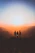 silhouette of three people up on mountain cliff