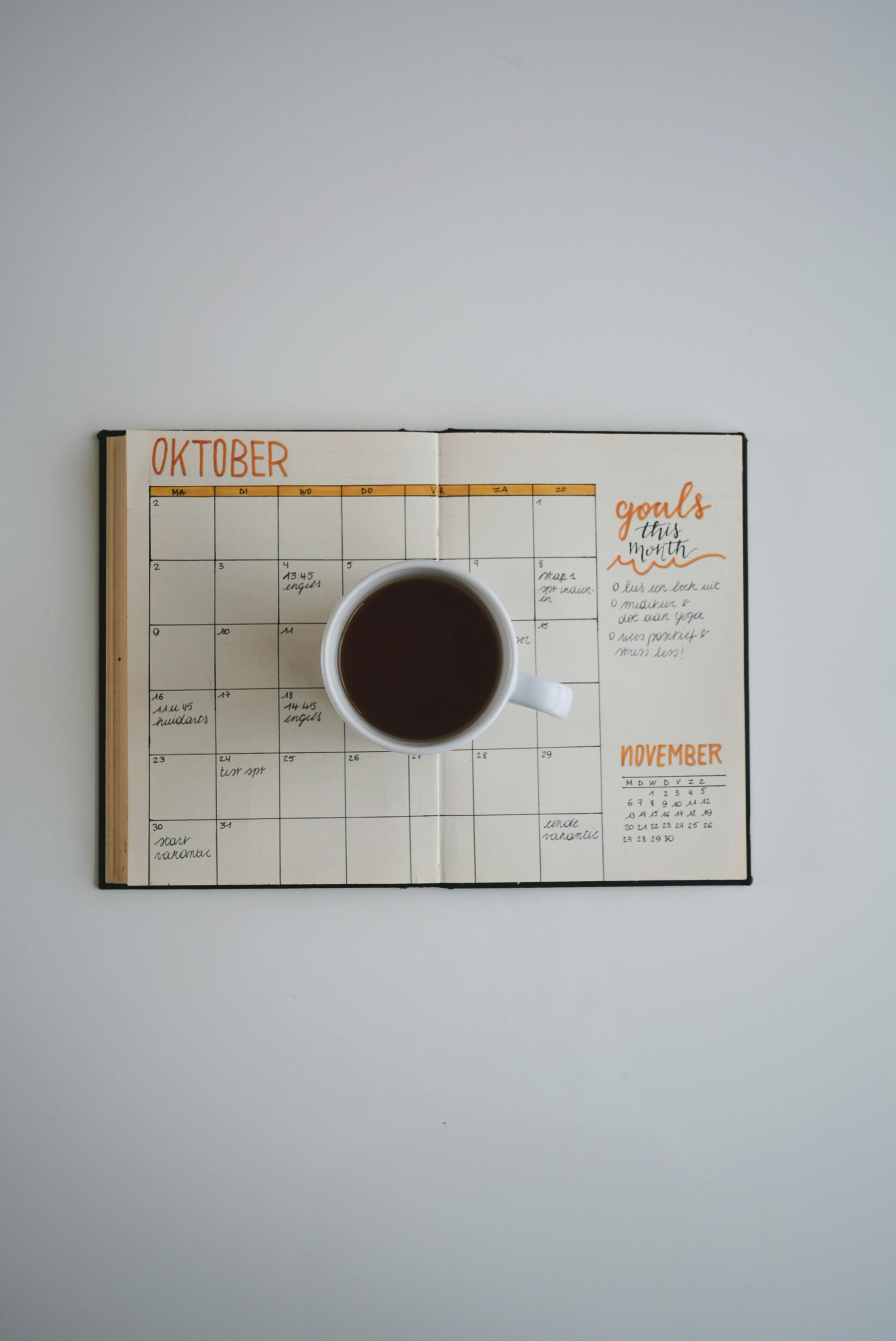 white coffee mug on calendar at october