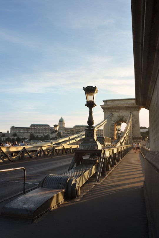 photography of people walking on gray bridge in Szechenyi Square Hungary