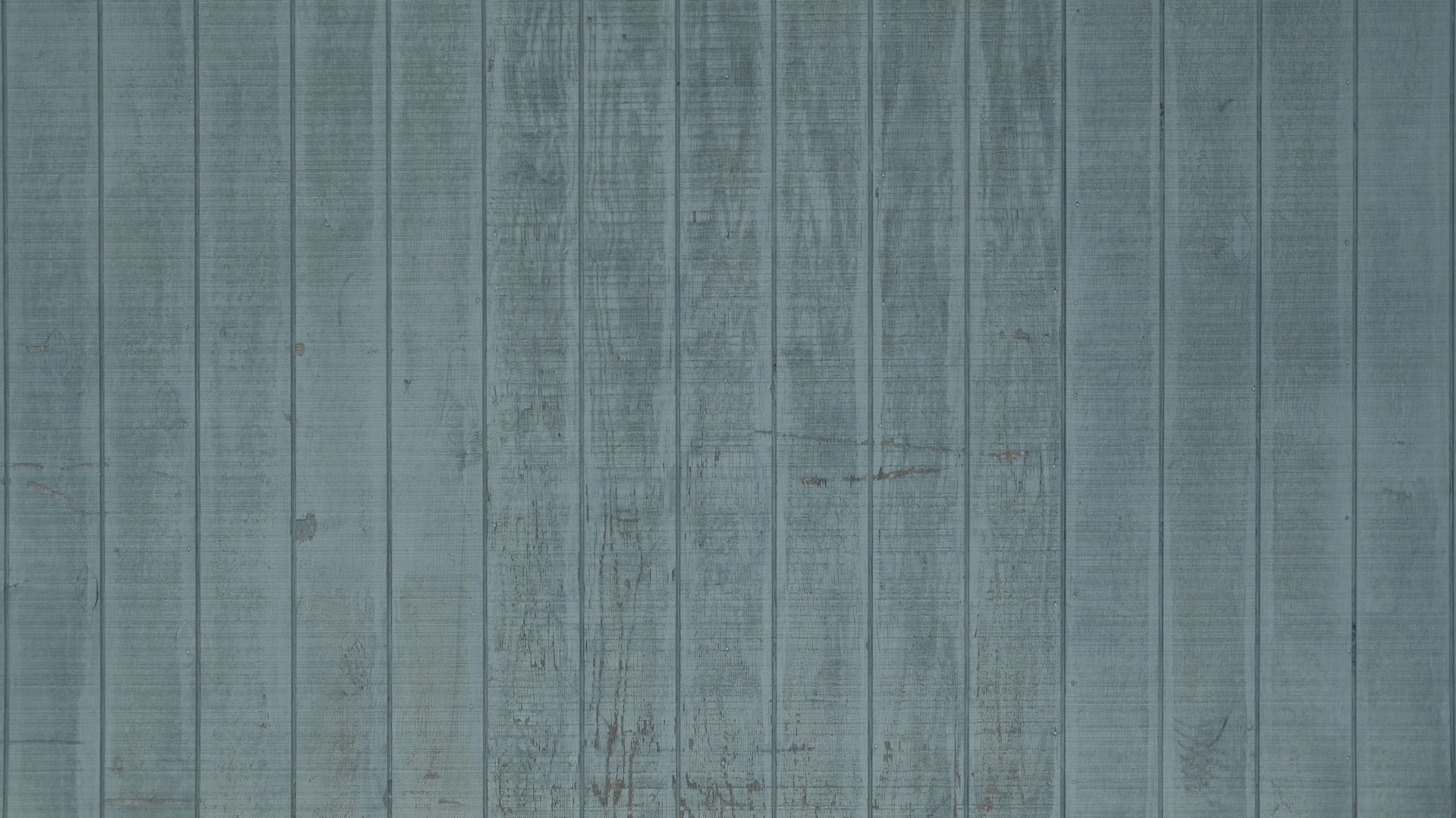 a blue wall with a bench in front of it