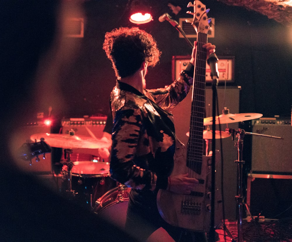 man holding electric guitar