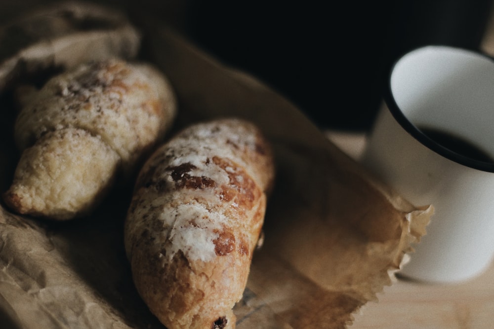 two breads beside white cup