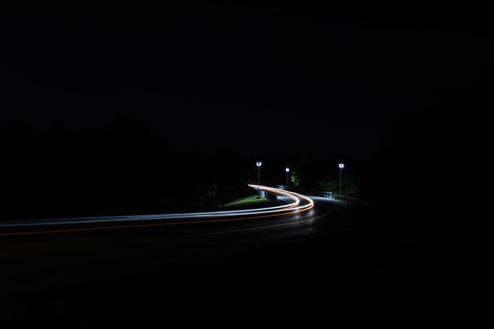 time-lapse photography of moving vehicles on road