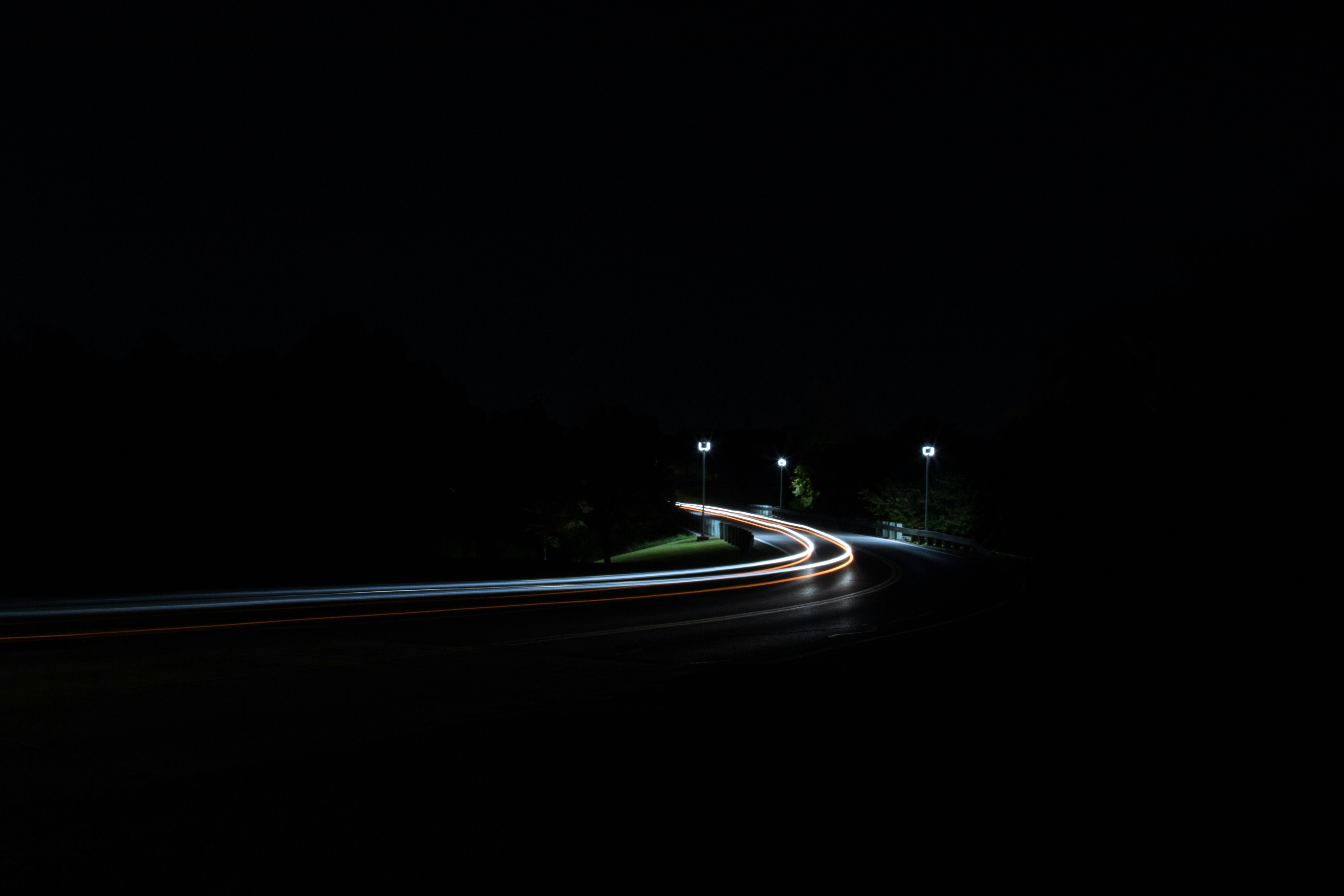 time-lapse photography of moving vehicles on road