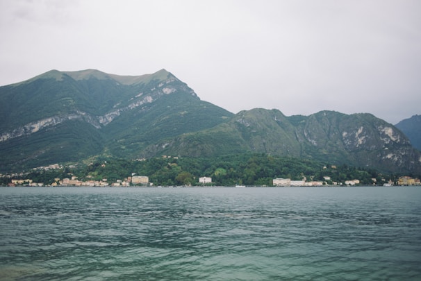 Serene lakeside view in Nainital surrounded by mountains.