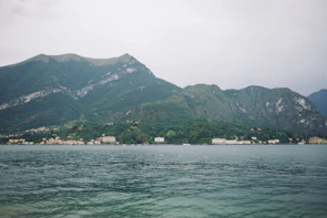 A serene lakeside view from a hidden heaven home stay surrounded by lush greenery.