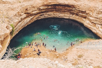 group of people swimming on body of water