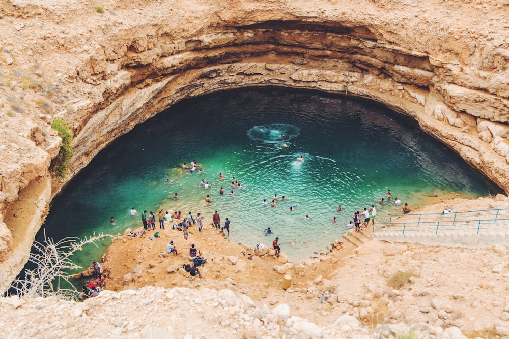 group of people swimming on body of water