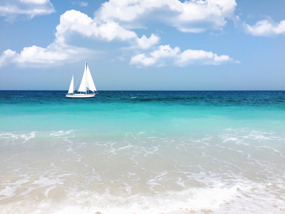 white sailboat on body of water during daytime