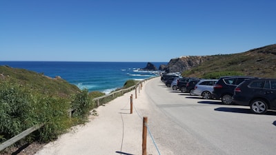 Beautiful Croatian coastline with rental vehicles parked nearby.