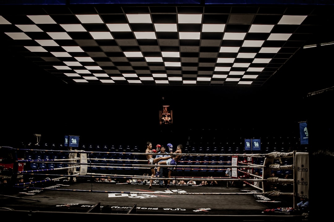  two man in blue and red pair of gloves on boxing ring match box