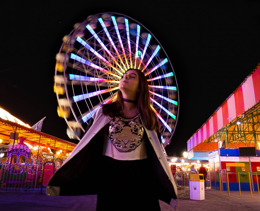 woman in front of ferry's wheel