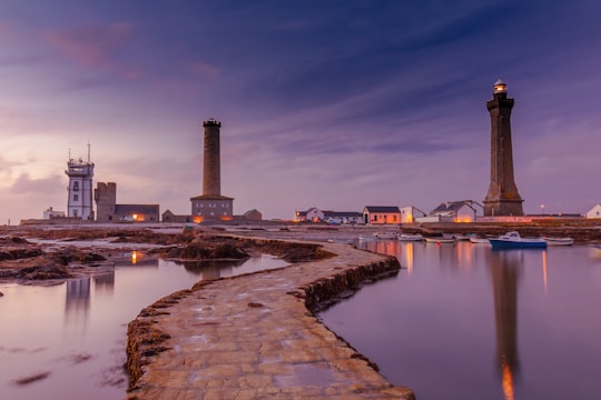 lighthouse tower near body of water in Phare d'Eckmühl France