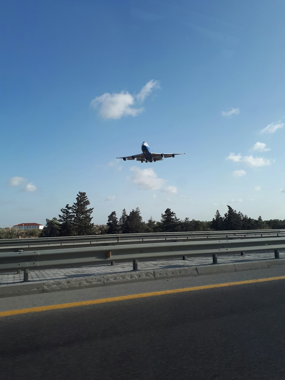 blue and white airplane under blue sky