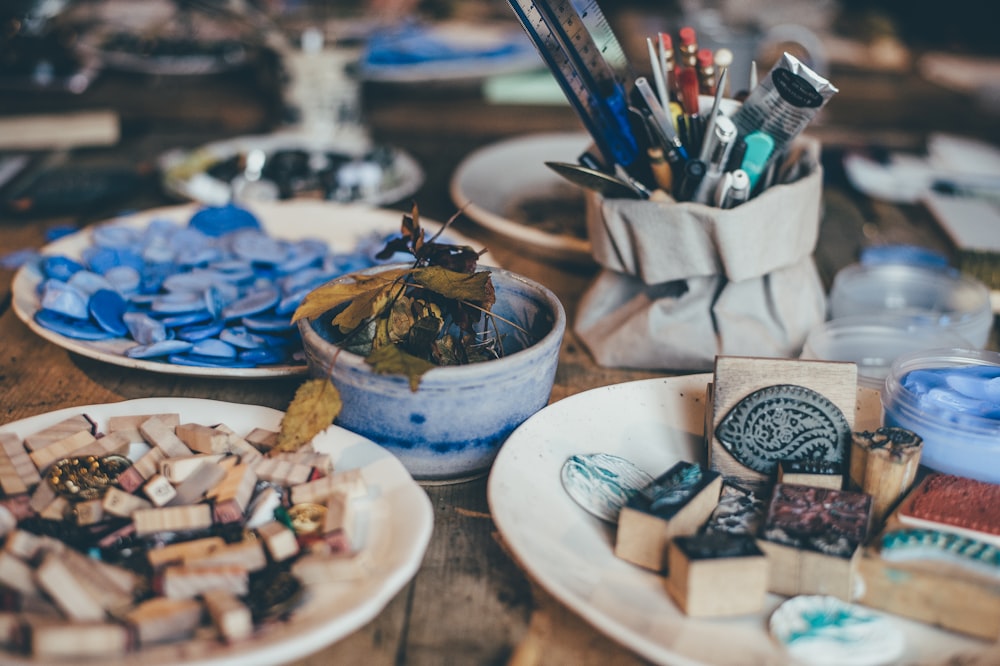 closeup photo of white ceramic plates with assorted-color piece lot