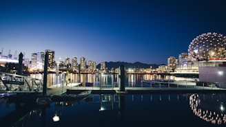 boats docked near concrete structures in vancouver science world 