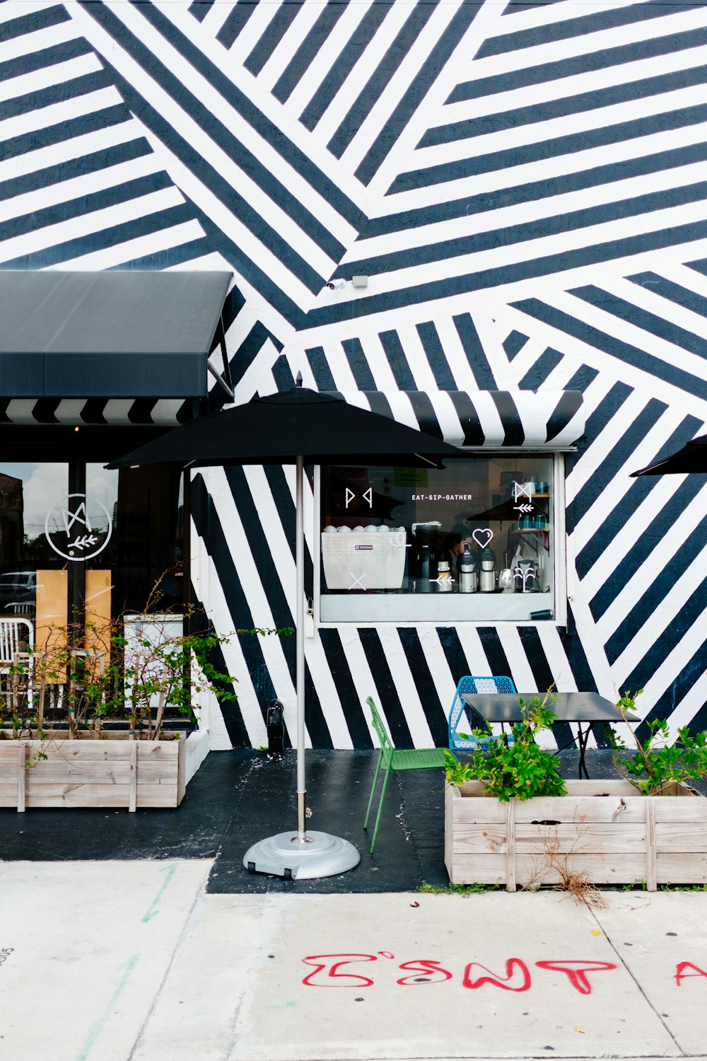 a black and white striped building with a black umbrella