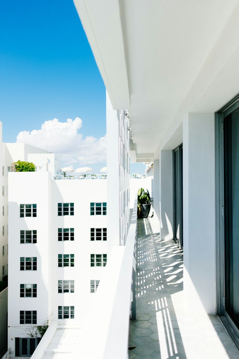 a balcony with a view of buildings and a blue sky