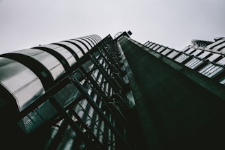 A striking architectural shot of a modern Birmingham industrial building with navy and gold accents under a slate-grey sky.