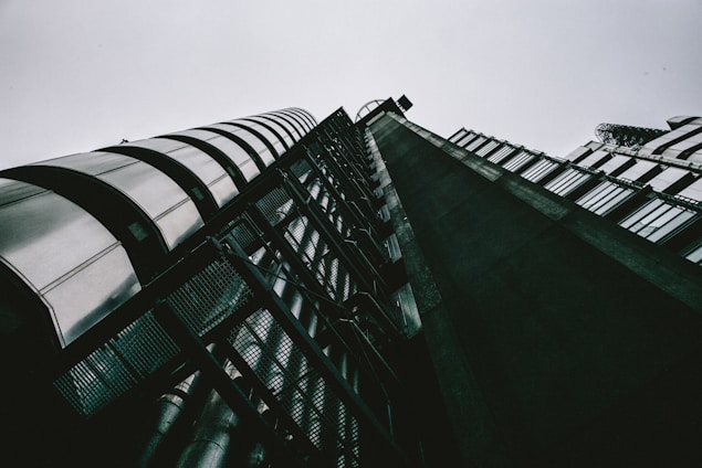 A striking architectural shot of a modern Birmingham industrial building with navy and gold accents under a slate-grey sky.