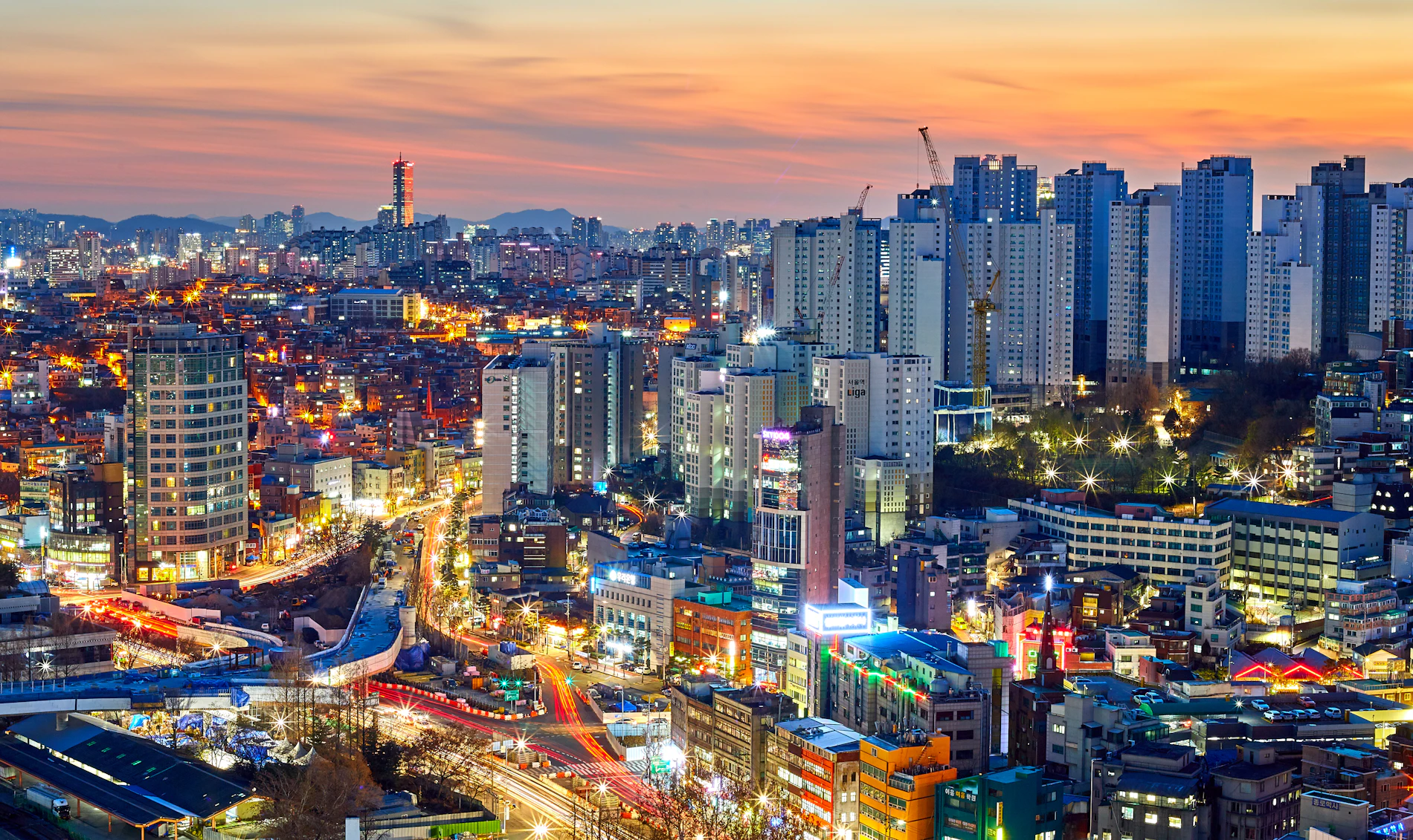 The Seoul cityscape under a warm evening sky