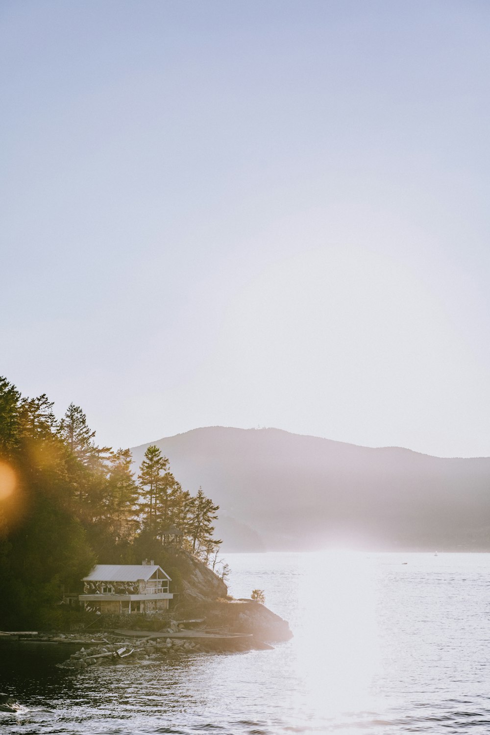 white cabin near body of water