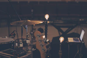 A warmly lit rehearsal room with musicians tuning their instruments, capturing the creative energy of sonaría.