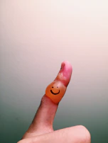 A charming finger-painting of a family holding hands under a sunny sky.