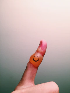 A charming finger-painting of a family holding hands under a sunny sky.