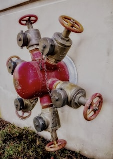 Brass washing machine valve installed on a wall with visible plumbing