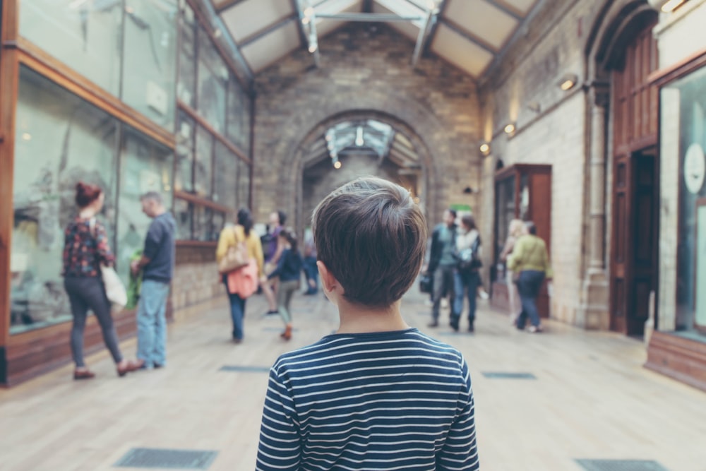 boy standing inside closed room