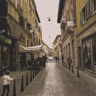 Historic street in a European city with cobblestones and cafes.