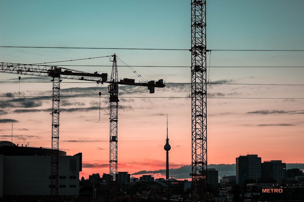 silhouette of crane trucks