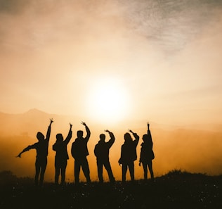 silhouette photo of six persons on top of mountain