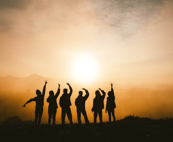 silhouette photo of six persons on top of mountain