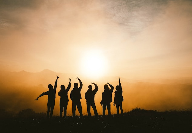 silhouette photo of six persons on top of mountain