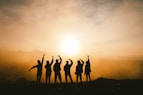 silhouette photo of six persons on top of mountain